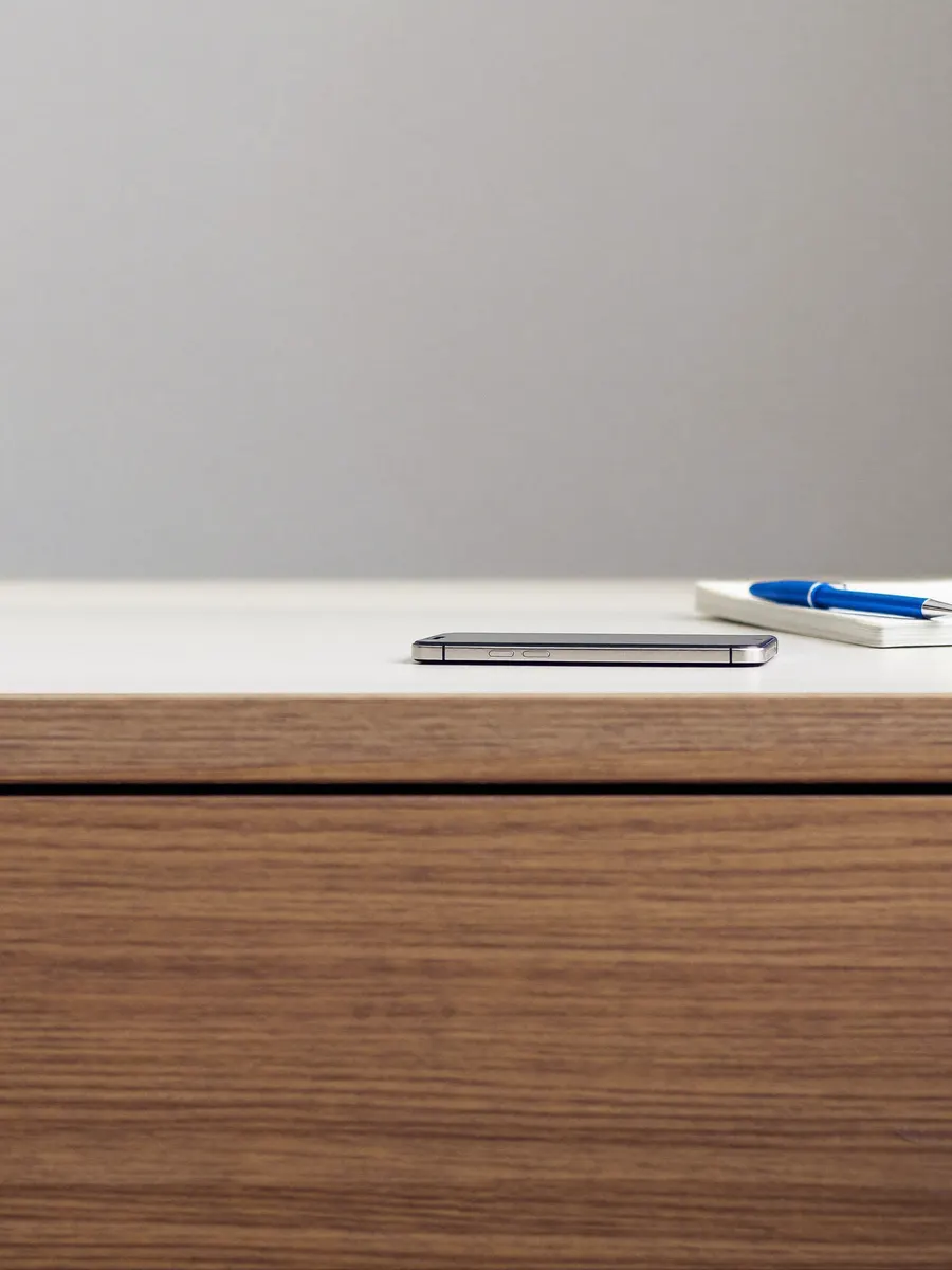 A phone and notebook ready for a short call