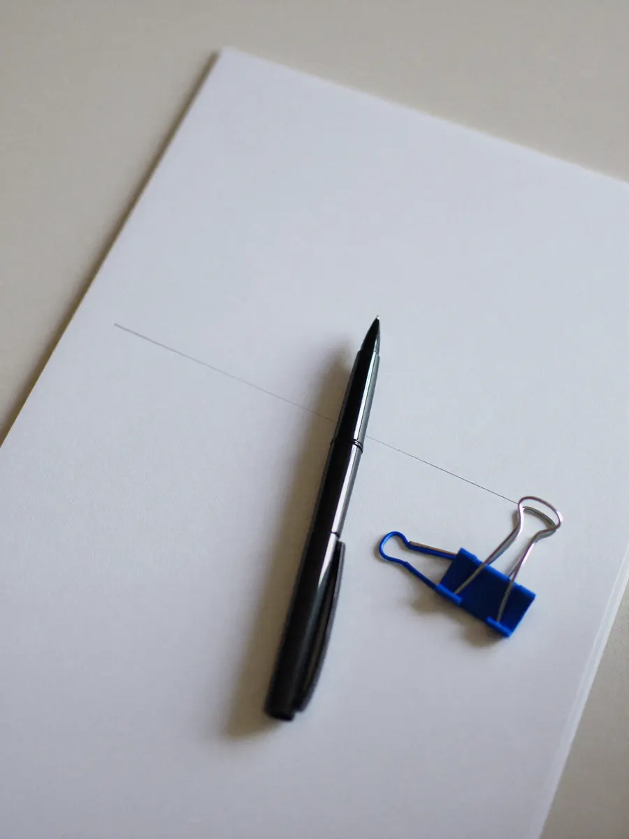 A written scope document with a pen